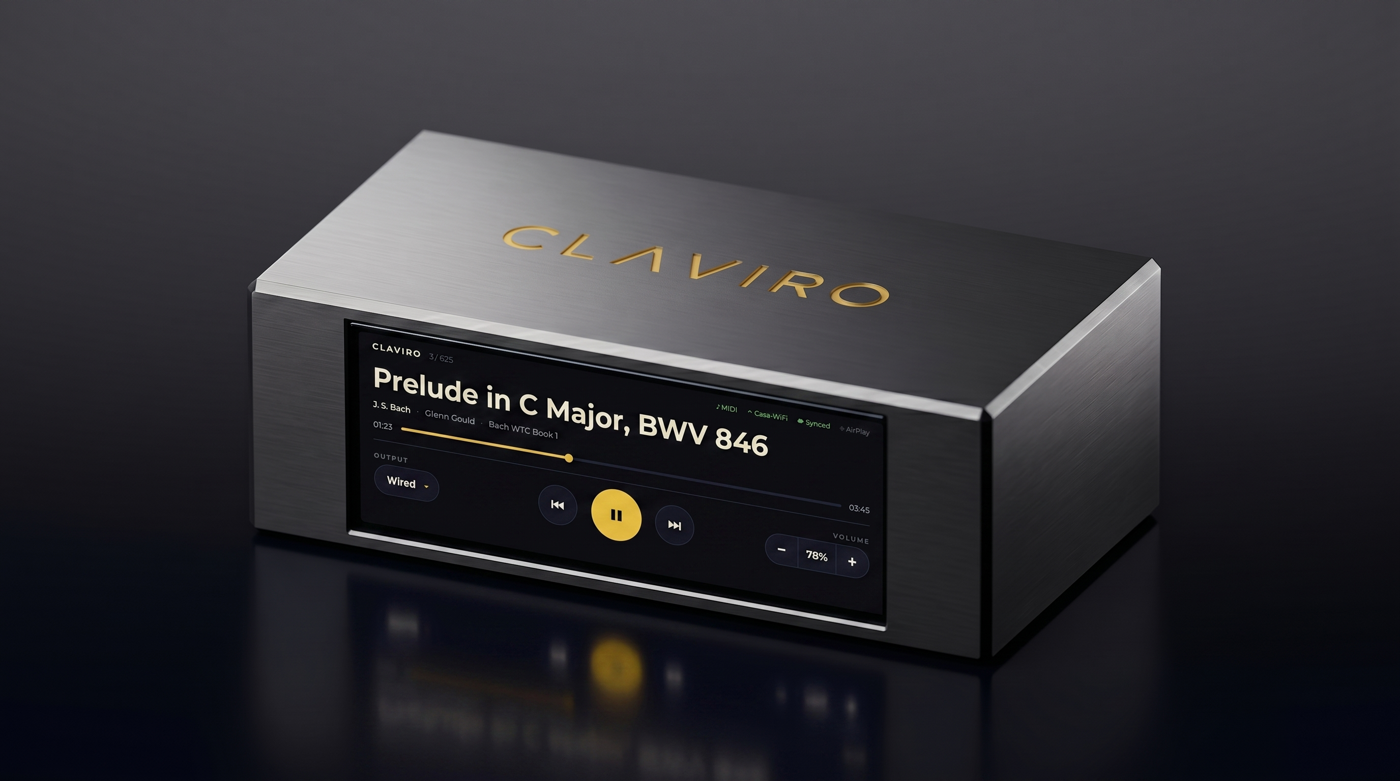 Claviro One — a slim brushed-aluminum bar with a wide display and the CLAVIRO wordmark engraved in gold, on a dark reflective surface